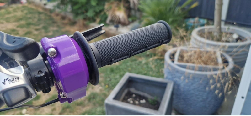 Purple Surron-style twist throttle on a KirbEbike customer's converted bike